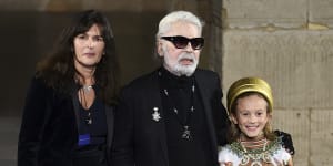 Virginie Viard,left,with Karl Lagerfeld and his godson Hudson Kroenig during the finale of the Chanel Metiers d'Art 2018/19 Show at the Metropolitan Museum of Art on Tuesday,December 4,2018,in New York. 