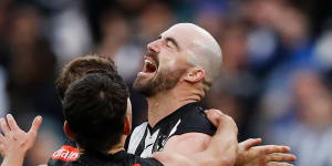 Steele Sidebottom and his Magpies teammates celebrate a key late goal against North Melbourne.