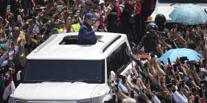 Prabowo Subianto waves to supporters after being sworn in as Indonesia’s eighth president in Jakarta.