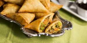 A plate of samosas - an appetizer commonly found in Indian restaurants - with onion-tomato chutney,mint-coriander chutney and tamarind sauce for dipping. credit:istock one time use for Traveller only brian johnston traveller 10