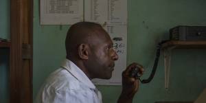 Mougulu health worker Jamie Gubego assists a woman in labour over a two-way radio.