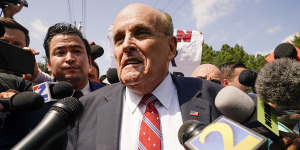 Rudy Giuliani speaks outside the Fulton County jail in Atlanta.
