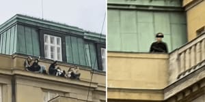 Students hide from the shooter on the ledge of one of the university buildings in Prague.