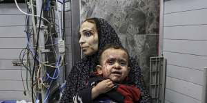 Wounded Palestinians,many of whom are women and children,wait for treatment at the al-Shifa hospital,in Gaza City.