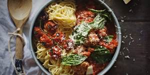 Spaghettini and meatballs scattered with fontina cheese.