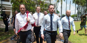 Constable Zachary Rolfe (centre) leaves the Northern Territory Supreme Court on Friday. 