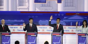 Former vice president Mike Pence (left),Florida Governor Ron DeSantis,businessman Vivek Ramaswamy and former UN ambassador Nikki Haley raise hands in support of Trump at the first Republican debate.