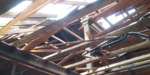 A damaged rooftop and broken wooden ceiling let sunlight into a middle school in Let Yet Kone village.