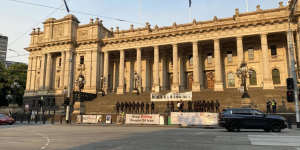 An antisemitic sign is held on the steps of Victoria’s parliament.