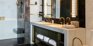 A double vanity,standalone bath and walk-in shower feature in the bathroom of a deluxe king room.