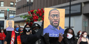 Demonstrators carry a symbolic coffin and images of George Floyd during an ‘I Can’t Breathe’ Silent March For Justice in Minneapolis,Minnesota,ahead of the trial.