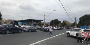 Pedestrians walk around idle Melbourne Show traffic on Langs Road on the weekend.
