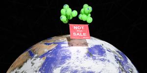 Greenpeace activists float a sign over a globe at the COP26 summit venue. 