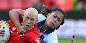 Canada’s Olivia Apps,left,is being brought down by Australia’s players