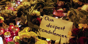 A message of condolence is left among candles and flowers near the Dutch embassy for victims of MH17.