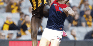 The heavy clash between Hawthorn’s Mabior Chol and Melbourne defender Steven May at the MCG.
