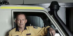 Former prime minister Tony Abbott pictured on Sunday in his role as a volunteer firefighter. 