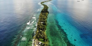 A strip of land between the Pacific Ocean,left,and lagoon in Funafuti,Tuvalu. The low-lying South Pacific island nation of about 12,000 people has been classified as ‘extremely vulnerable’ to climate change by the UN.