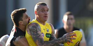Dustin Martin is tackled by Oleg Markov in last week’s practice match against Collingwood.