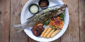 Spice-marinated and charcoal-grilled whole boning fish.