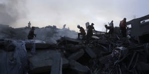Palestinians look for survivors under rubble.