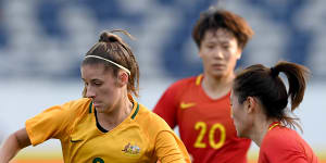 Matildas star Amy Harrison wins the ball from China's Wu Haiyan when they visited Geelong for a friendly in November 2017.