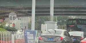 Peng Lifa with his banners on the Beijing overpass in October.