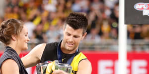 Ash Barty presents the 2020 AFL premiership cup to Trent Cotchin.