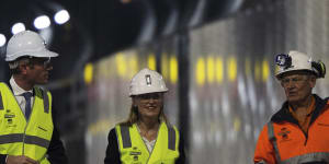 Premier Dominic Perrottet,Metropolitan Roads Minister Natalie Ward and Transurban’s Terry Chapman walk the WestConnex M4-M5 Link tunnel on Thursday.