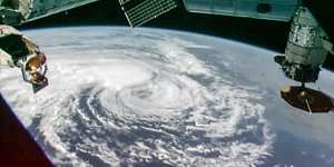 As Cyclone Alfred,seen here from space,bore down in Australia,oil executives gathered in Houston,Texas.