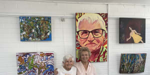 Brisbane-based artist Anne Collins,99,with friend Kathy Sullivan in Art Space Toowong.