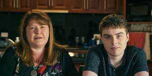 Callum with his mother Melinda Milkins:“we cannot force him to go to a place that is causing trauma and harm.”
