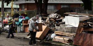 People clean out flood-damaged belongings in Maribyrnong on Sunday.
