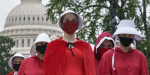 Activists opposed to the confirmation of Judge Amy Coney Barrett are dressed as characters from The Handmaid's Tale,a dystopian story in which women are denied reproductive rights,at the Supreme Court in Washington on October 11,2020.