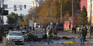 Police inspect the scene of Russian shelling in Kyiv on Monday.