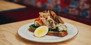 The Scandi,loaded up potato salad on sourdough with smoked salmon sauerkraut capers and pickles.