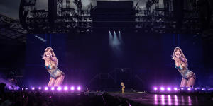 Triple treat:Taylor Swift,centre,is dwarfed by her twin images during her series of gigs at Accor Stadium in February 2024.