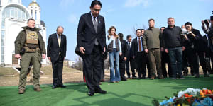 Japanese Prime Minister Fumio Kishida,centre,offers prayers,at a church in Bucha,a town outside Kyiv that became a symbol of Russian atrocities against civilians,in Ukraine.