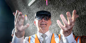 Albanese tries out some augmented reality glasses,used to simulate tunnelling equipment,during a tour today. 