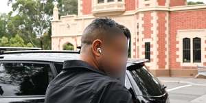 The father of a teenager accused of stabbing a priest in a Wakeley church leaves Parramatta Children’s Court.