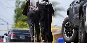Two women embrace near the scene of the San Diego shooting.