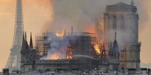 Flames and smoke rise from the burning Notre Dame on Monday night. 