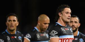 Nicho Hynes leads a dejected Cronulla side off the field after their loss to the Gold Coast.