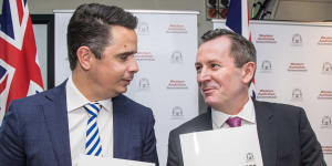 Western Australia Treasurer Ben Wyatt and Premier Mark McGowan open the state budget papers in front of the media prior to announcing the budget in parliament on Thursday,
