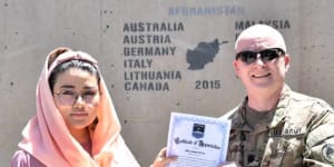 In this undated photo,Zainab Azizi receives a Certificate of Appreciation from a US Army member.
