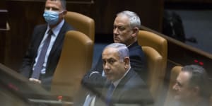 Outgoing Israeli Prime Minister Benjamin Netanyahu looks on after parliament voted to approve the new government and end his 12-year leadership.