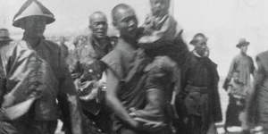 An attendant carries the new Dalai Lama,aged five or six in this photo (which dates it to around 1940),as he prepares to journey across the Himalayas to Lhasa,Tibet. Years later,he would flee to north India.