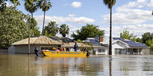 Emergency crews working at transporting people by boat over flooded streets in Forbes,NSW,last week. 