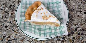Banana cream pie nut-sprinkled with golden pastry,softly gooey banana puree and piled whipped cream. 
