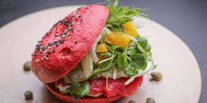 House-made beetroot bagel filled with salmon,watercress and egg.